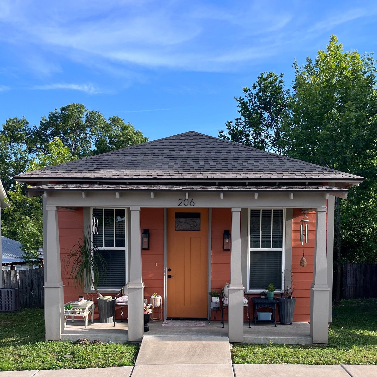 An orange one story ADU with full width front porch