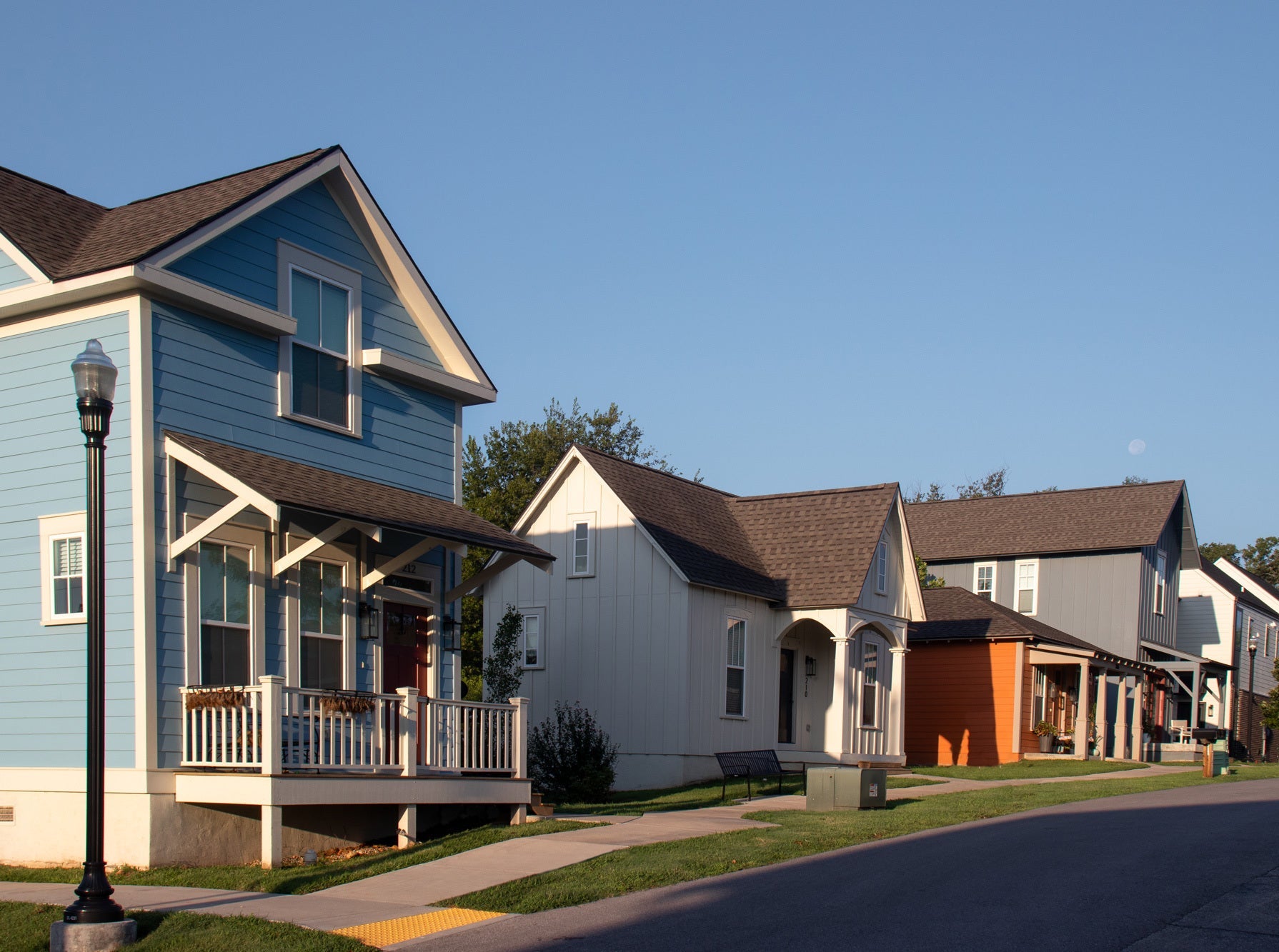 Row of houses along a street with clear blue sky